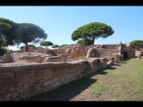 06500 ostia - regio iv - insula v - schola del traiano (iv,v,15) and domus (iv,v,16) - westseite - blick ri caseggiato delle taberne finestrate (iv,v,18) - ri nordwesten.jpg